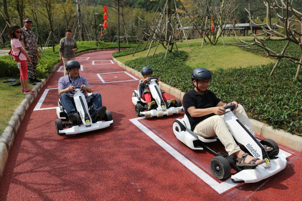Group enjoying a sunny go-kart racing day at an outdoor park. Excitement and speed for all ages.