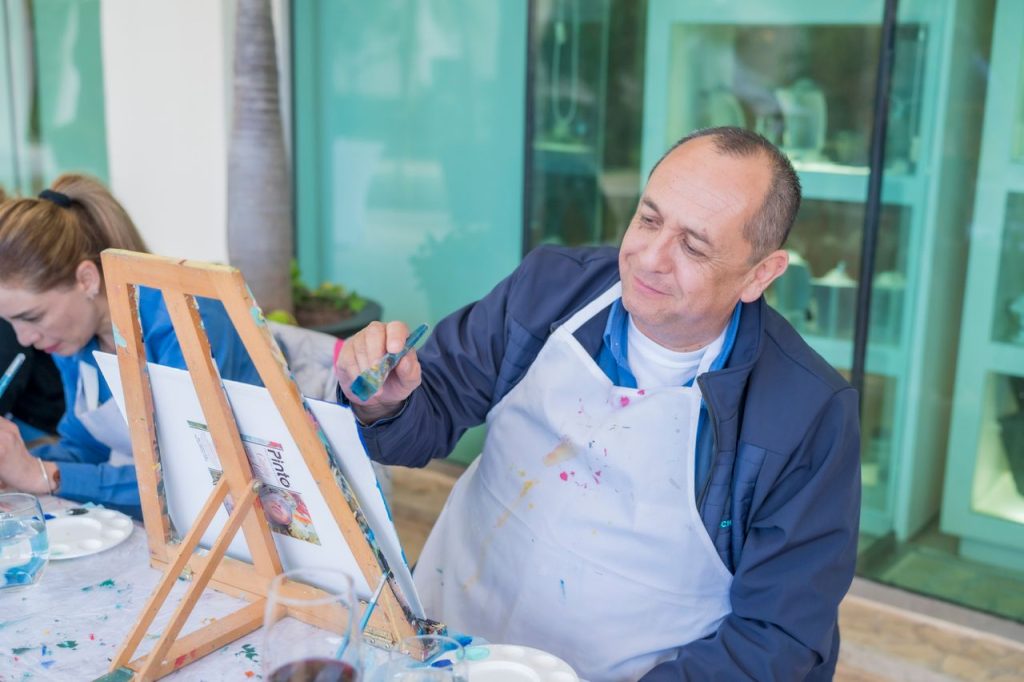 Adults engaging in a relaxing painting workshop, focused on creativity and leisure.